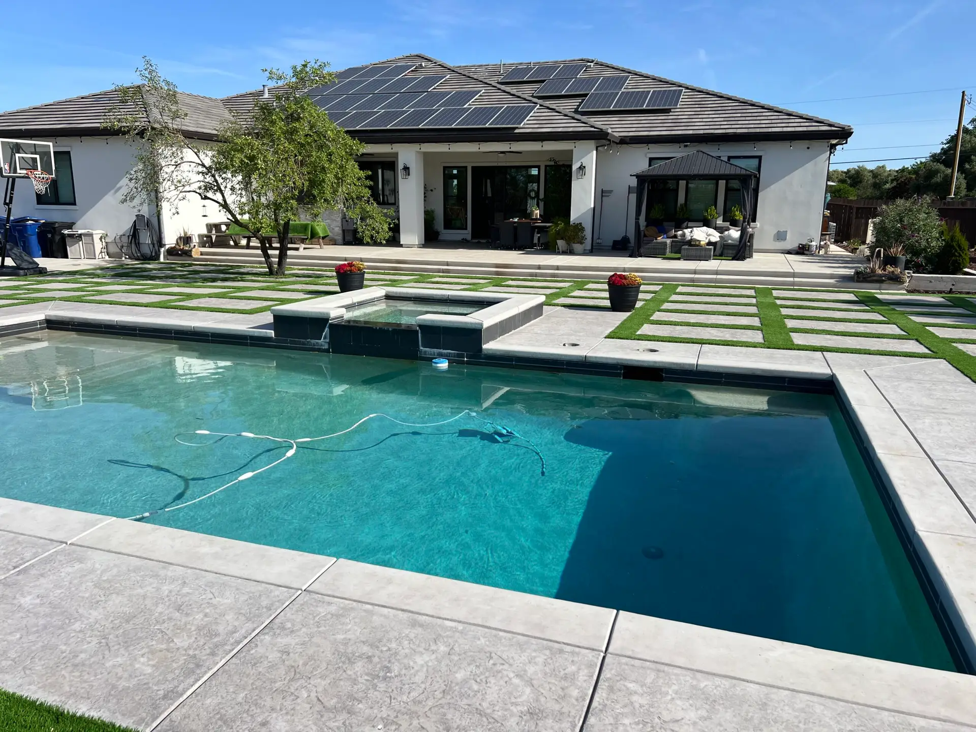Simple Pool Care technician cleaning a residential pool in West Palm Beach, FL